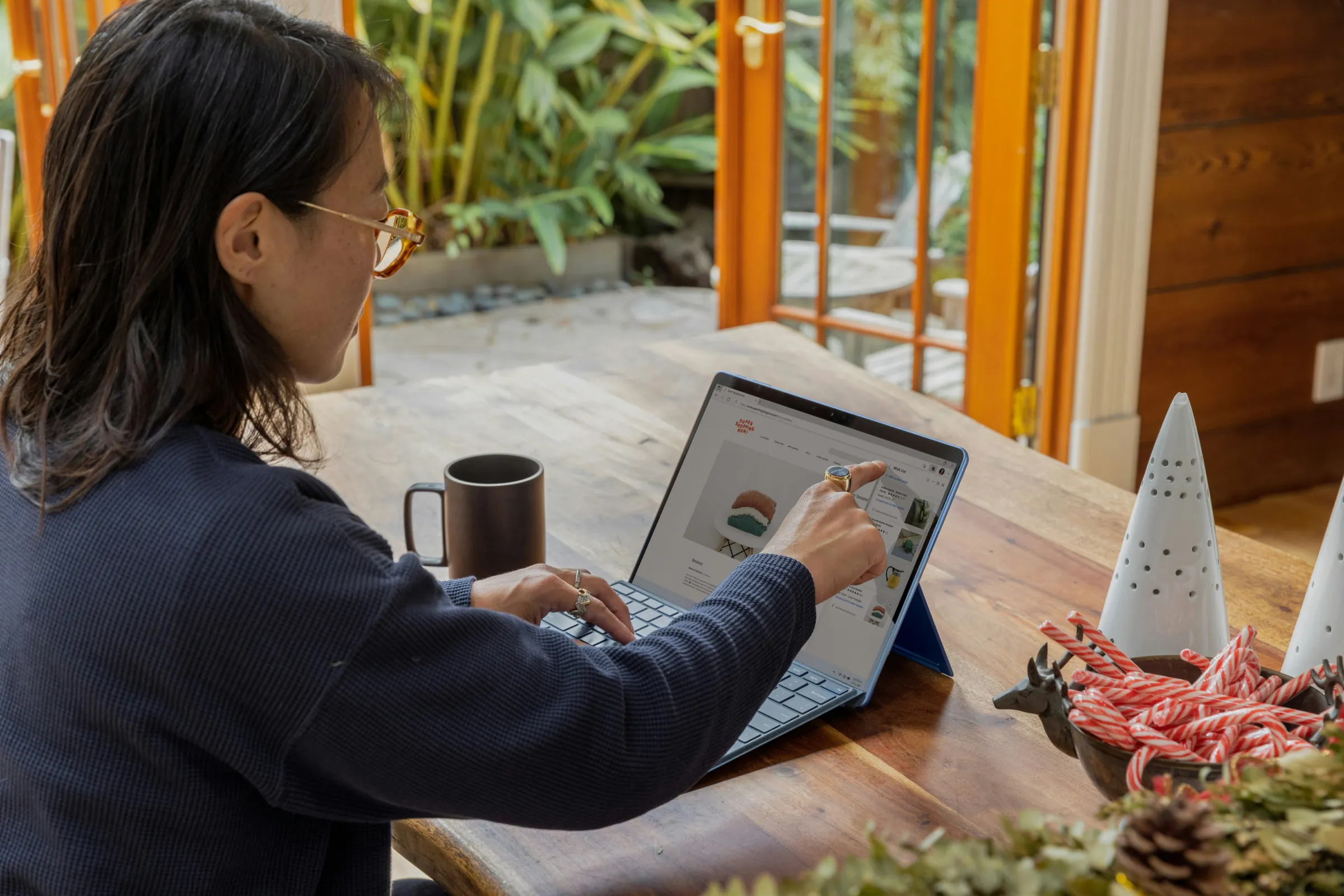 A woman reviewing an online store on a laptop and tablet