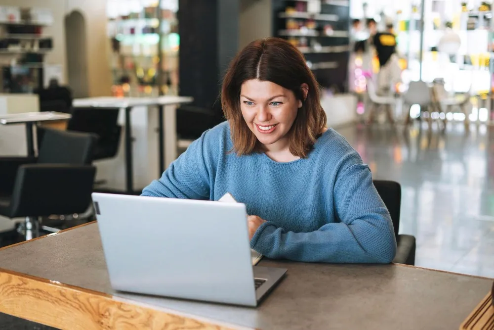 A woman using a laptop in a shared workspace